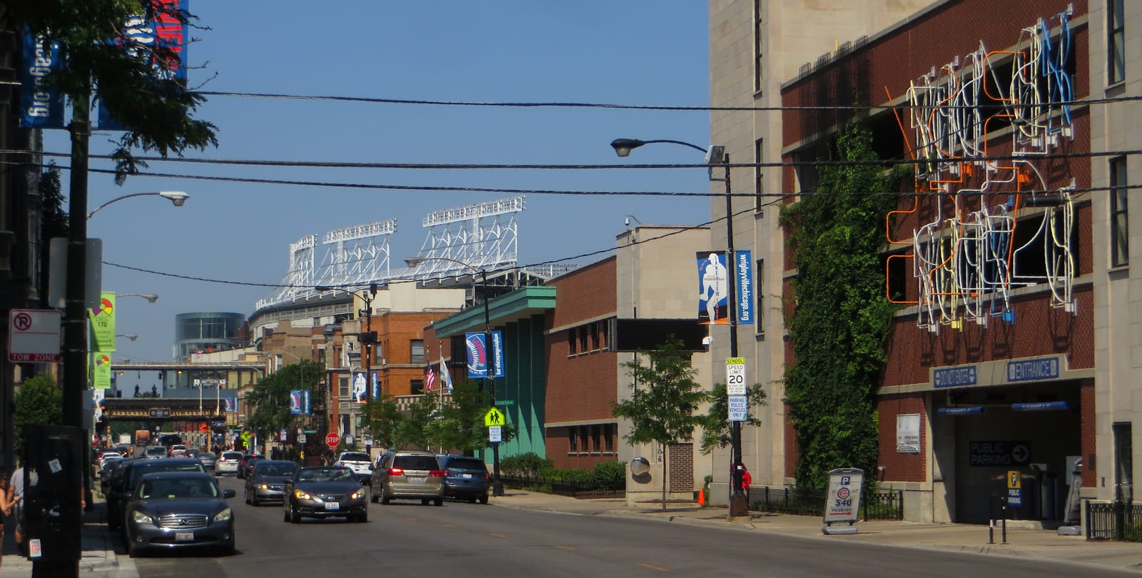 Looking down a Wrigleyville street toward the Wrigley Field marquee and ballpark in Chicago